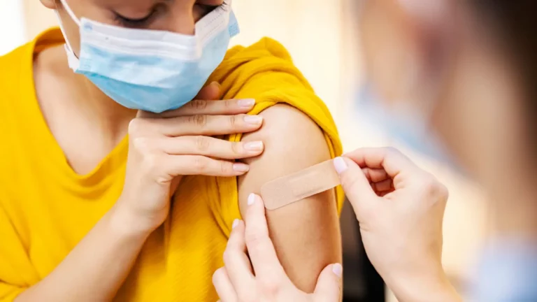 Woman Getting Bandaid After Vaccine