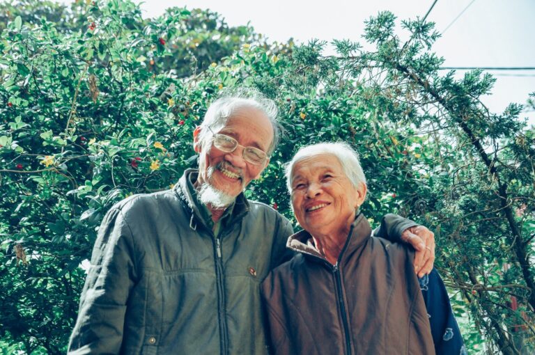 Asian man and his wife both smiling because they are being proactive about their health
