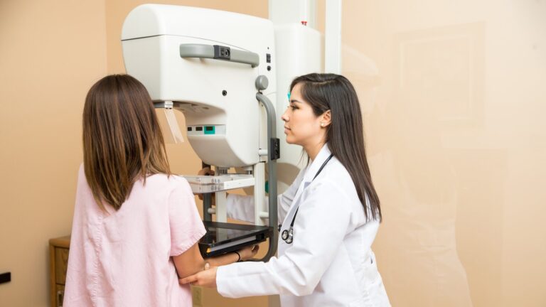 Doctor Helping Patient Get A Mammogram