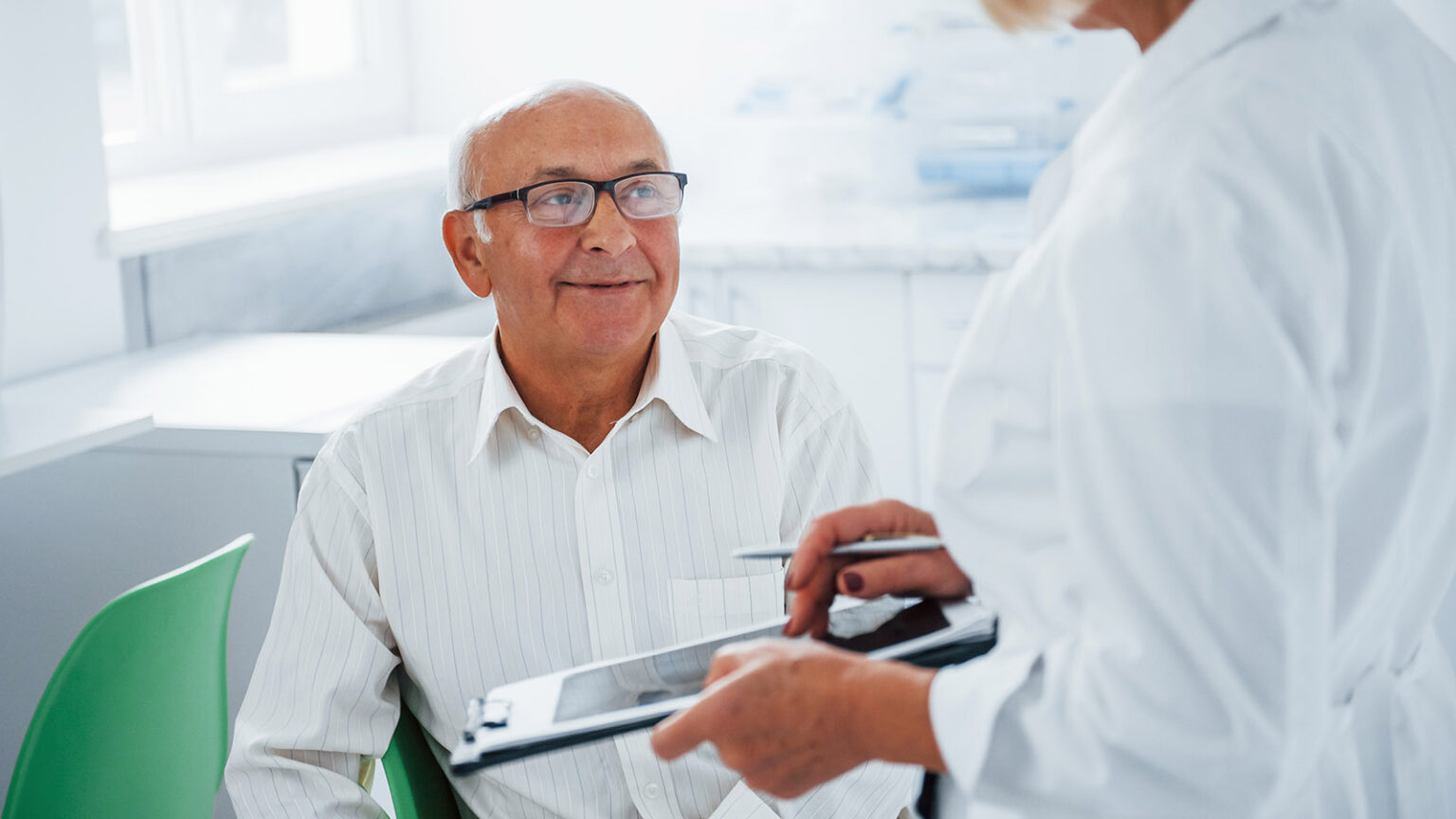 Senior Man Have Consultation In The Clinic By The Female Doctor