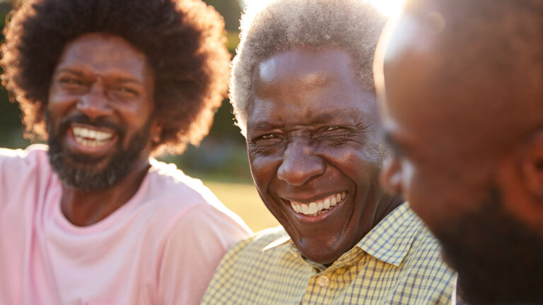 Senior Black Man Laughing With His Two Adult Sons, Close Up